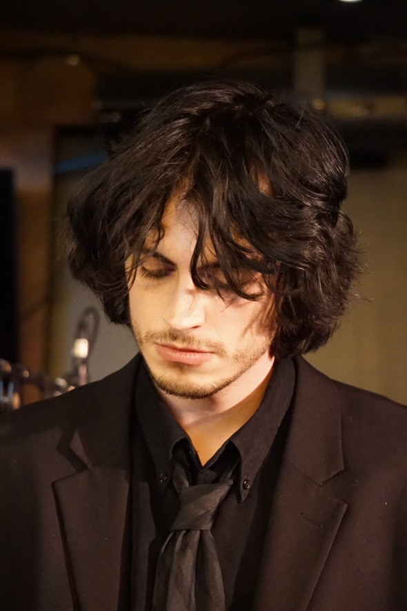 Rieley Hunt playing guitar on stage at Ollie's Pub & Patio at Carleton University